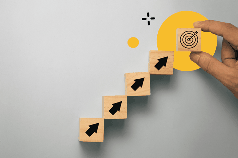Graphic showing building blocks representing company growth and reaching a goal.